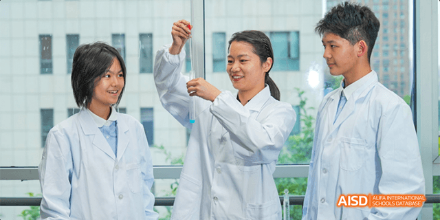 A female teacher or researcher in a white lab coat from the International Department of Chengdu Shude High School holding up a test tube for examination in a science lab.