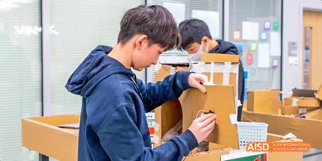 A student from the International School of Beijing works on a creative construction project.
