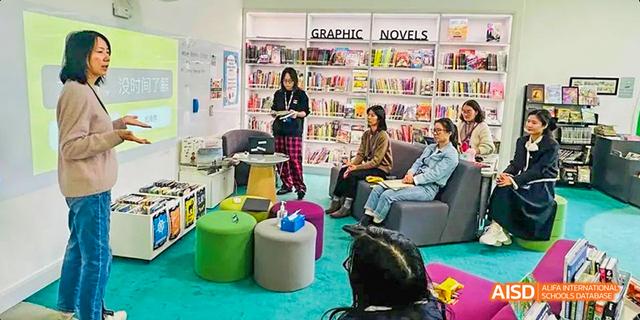 A group of students from the International School of Beijing are shown reading books together in the library.