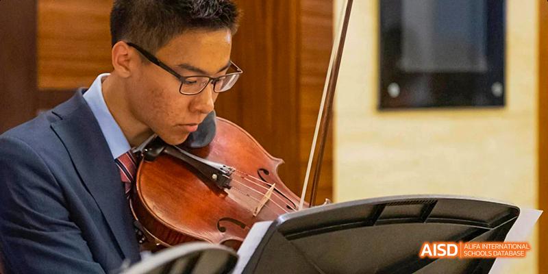 A student from the International School of Beijing plays the cello during a music performance.