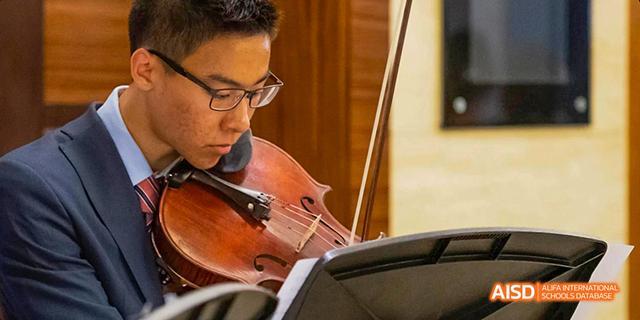 A student from the International School of Beijing plays the cello during a music performance.