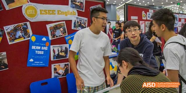 An adult and a student from the International School of Beijing chat during a school event.