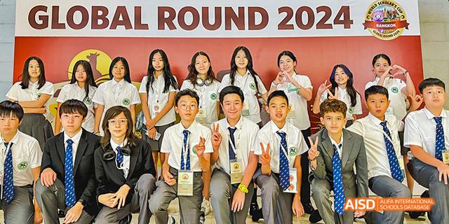 A diverse group of smiling International School of Dongguan students wearing school uniforms posing together for a group photo.