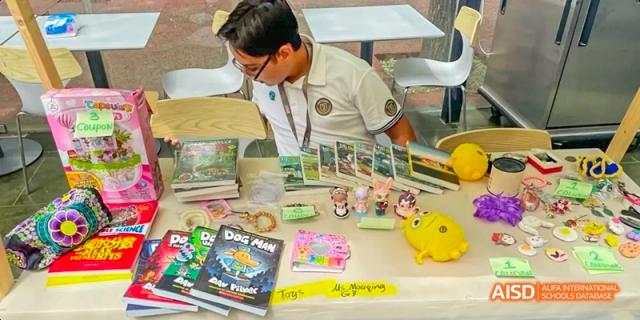 Students from JPED Academy, working on a science project at a table with various materials.