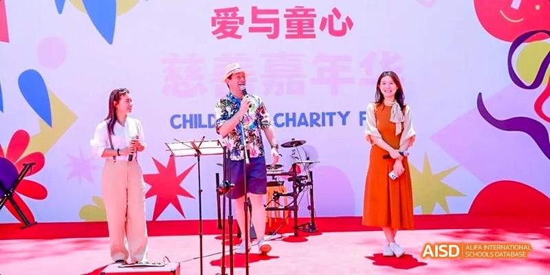 A group of students from JPED Academy, performing on a stage during a concert or event.