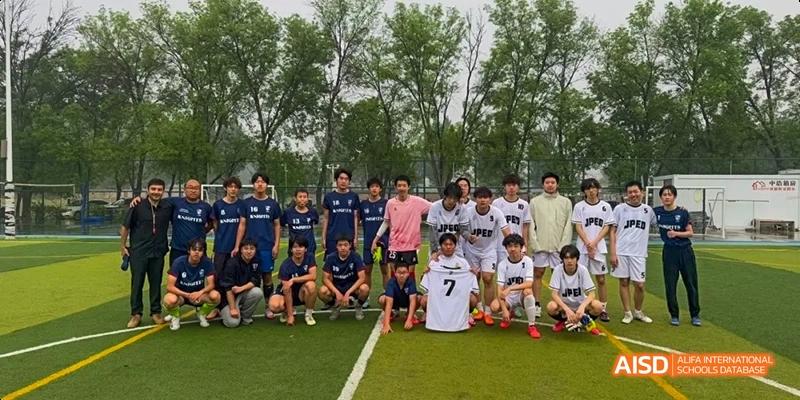 A group of male students from JPED Academy, posing for a group photo on a sports field.