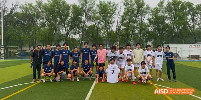 A group of male students from JPED Academy, posing for a group photo on a sports field.