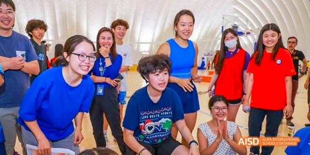 A group of students from JPED Academy, smiling while posing for a photo together.