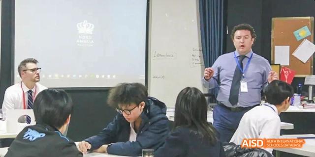 A male student focused on his work in a classroom, Léman International School Chengdu