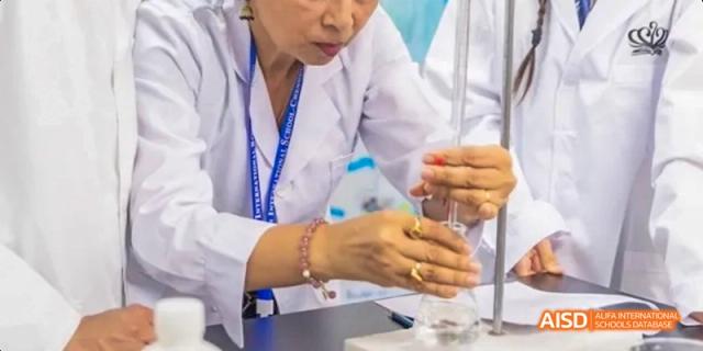 A science teacher demonstrating an experiment to a student, Léman International School Chengdu