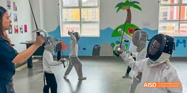 Students participating in a fencing class in a school gym, Léman International School Chengdu