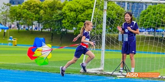 A young girl running a race on a sports track, Léman International School Chengdu