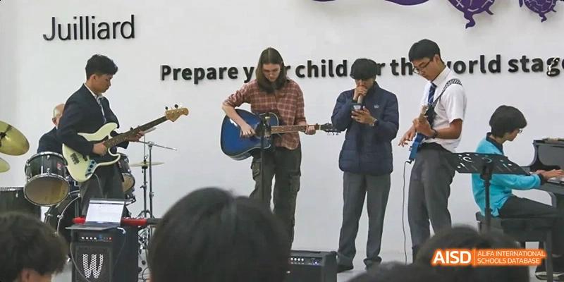 Two students playing guitars while others watch, Léman International School Chengdu