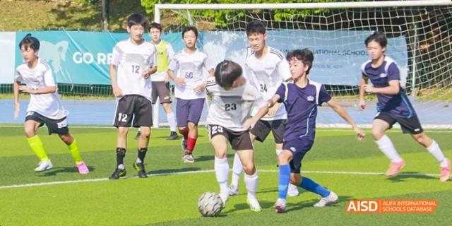 Students playing a soccer game on a field, Léman International School Chengdu