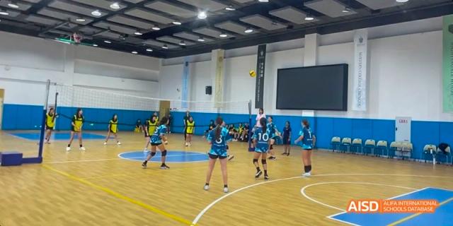 Students playing a game of volleyball in a gymnasium, Léman International School Chengdu