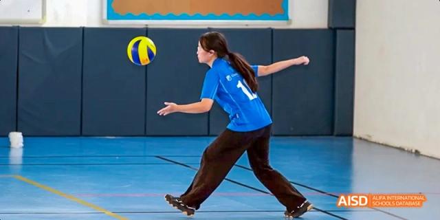 A female student serving a volleyball during a game, Léman International School Chengdu