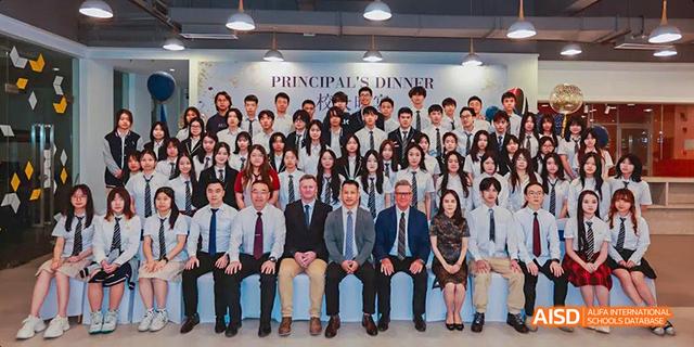 A large group of students and teachers in a formal group photo at Majestic International College.