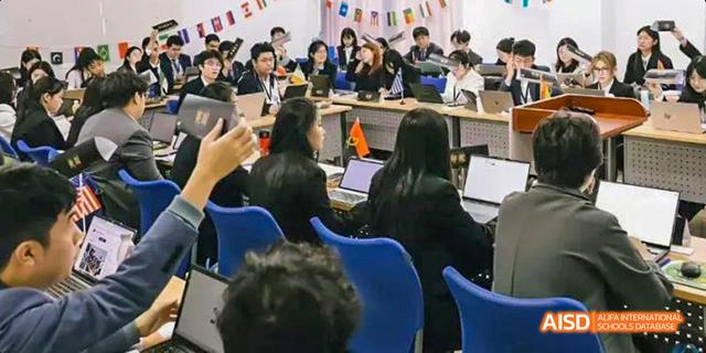 Students engaged in a classroom lecture, with some using laptops, at Majestic International College.
