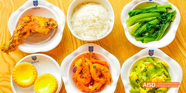 A bowl of cooked shrimp and a bowl of white rice, part of a meal served at Majestic International College.
