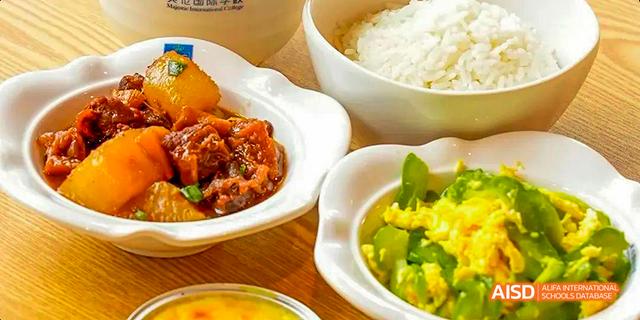 A close-up of several Chinese food dishes, including a spicy bowl and an egg dish, at Majestic International College.