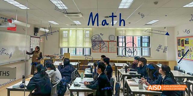 A wide shot of an empty classroom with a "Math" sign above the blackboard at Malvern College Chengdu.