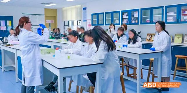 A group of students in lab coats are working on a science experiment at Malvern College Chengdu.