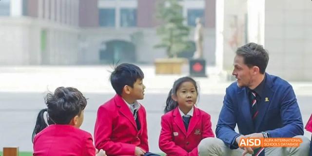 A young boy and girl in school uniforms at Maple Leaf International School - Luoyang.