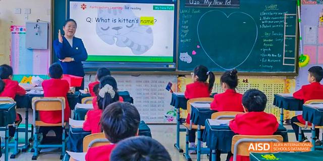 A classroom with a teacher instructing students using a smart board at Maple Leaf International School - Luoyang.