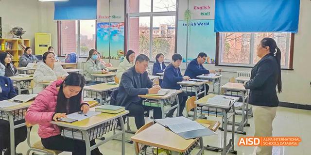 A class of students listening to a teacher in a classroom at Maple Leaf International School - Luoyang.
