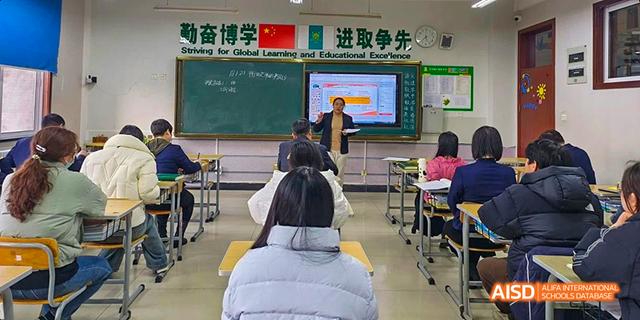 A teacher standing in front of a class of students at Maple Leaf International School - Luoyang.