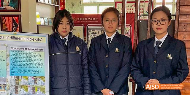 Two students in school uniforms posing for a photo at Maple Leaf International School - Luoyang.
