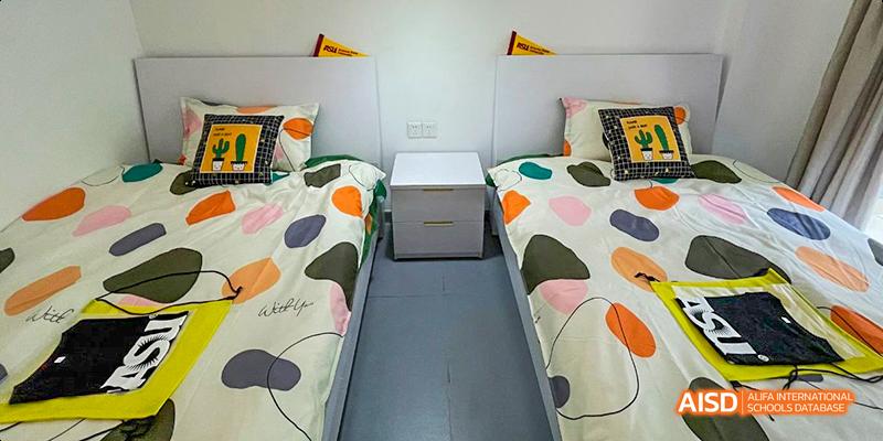 A student dormitory room with two beds at Maple Leaf International School - Luoyang.