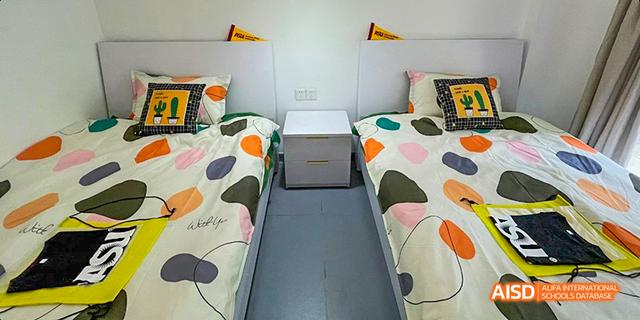 A student dormitory room with two beds at Maple Leaf International School - Luoyang.