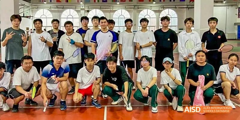 A group of male students posing for a photo on an indoor sports court at Maple Leaf International School - Luoyang.