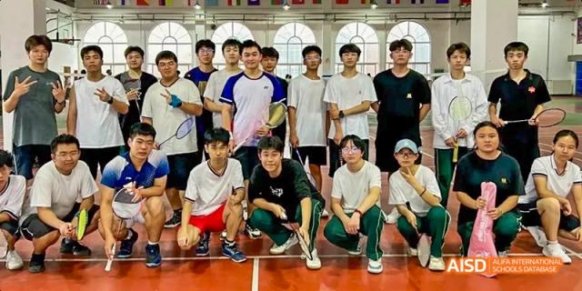 A group of male students posing for a photo on an indoor sports court at Maple Leaf International School - Luoyang.
