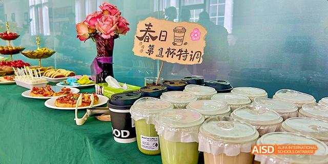Two takeout cups of green beverages on a table at Maple Leaf International School - Luoyang.