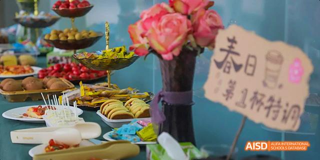 A decorative photo of a vase of flowers and a bowl of noodles at Maple Leaf International School - Luoyang.
