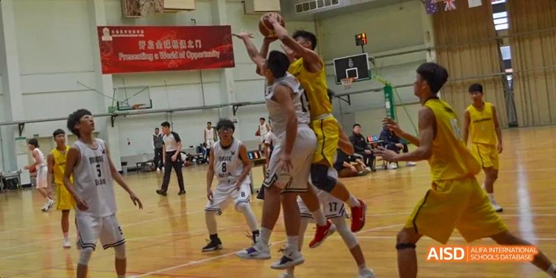 Students playing basketball during a game at Maple Leaf International High School - Dalian