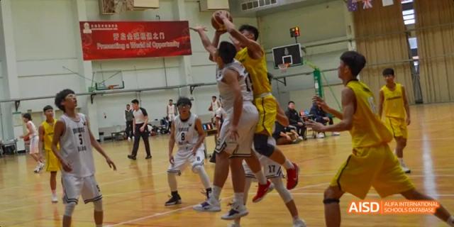 Students playing basketball during a game at Maple Leaf International High School - Dalian