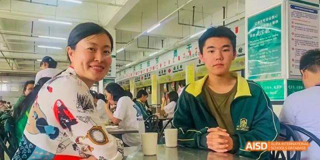 Two male students at Maple Leaf International High School - Dalian sitting at a table in a cafeteria.