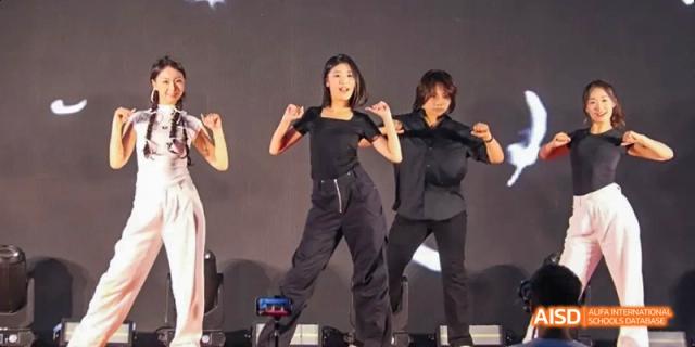Two students from Maple Leaf International High School - Dalian dancing on a stage.