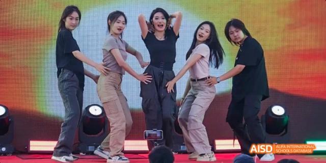 A group of students from Maple Leaf International High School - Dalian performing a dance in a competition.