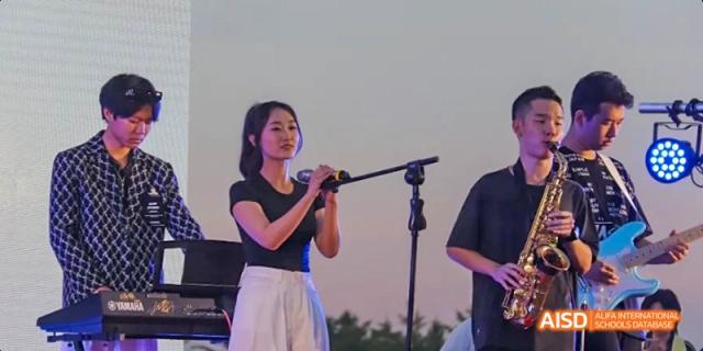 A student from Maple Leaf International High School - Dalian performing on stage.
