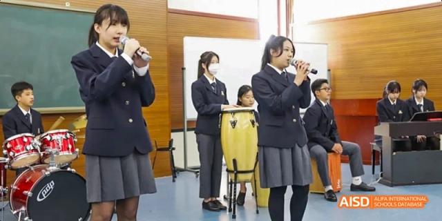 Two students from Maple Leaf International High School - Dalian in uniform playing instruments.