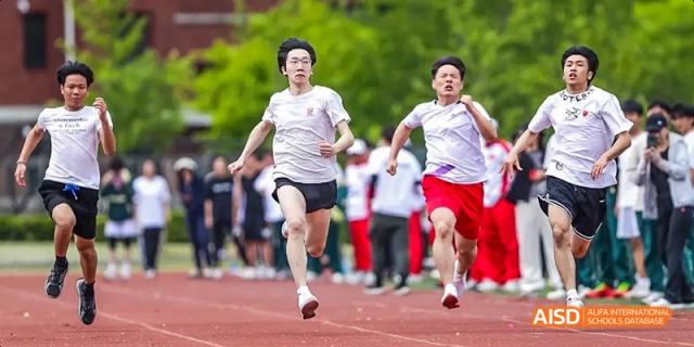 A male student from Maple Leaf International High School - Dalian running on a track during a race.