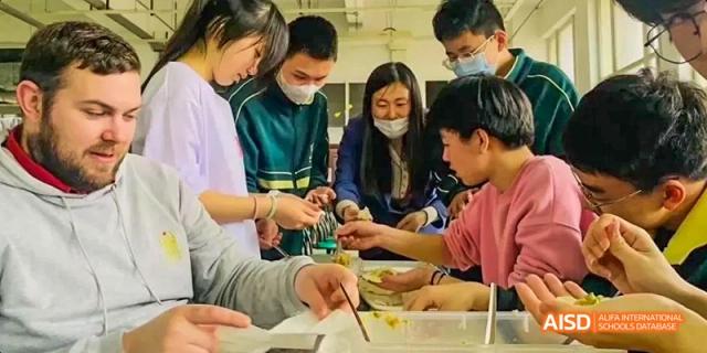 Students from Maple Leaf International High School - Dalian are eating with chopsticks.