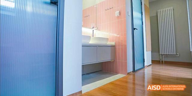 The interior of a clean, modern bathroom at Beijing Aidi School.