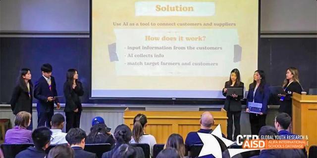Students from Beijing Aidi School giving a presentation with a "Solution" slide on a projector.