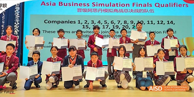 Beijing Aidi School students receiving awards and holding certificates at a ceremony
