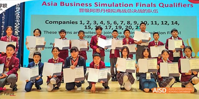 Beijing Aidi School students receiving awards and holding certificates at a ceremony